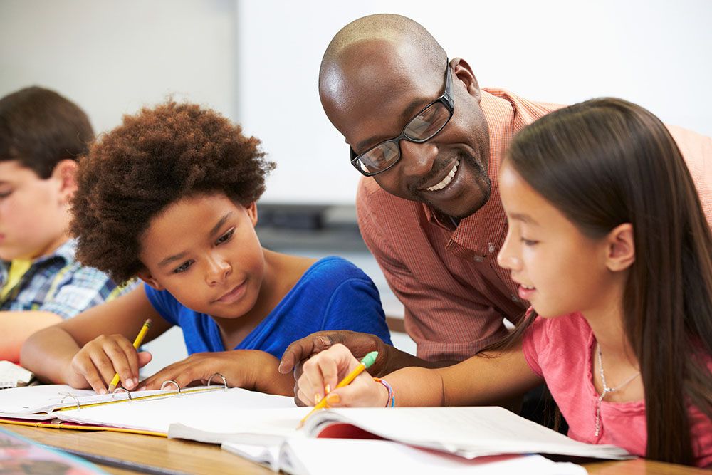 Teacher helping pupils